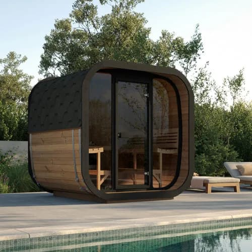 SaunaLife CL7G cube sauna beside a pool, glass front and door with trees and a lounge chair behind