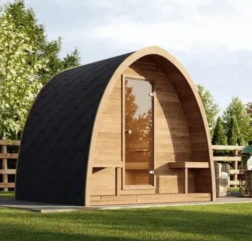 SaunaLife G3 pod cabin in a fenced garden, black shingled arch over a wood front with glass door